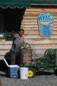 September 4 turned out to be a gorgeous day and hot enough for Nate Bryan, owner of Wake and Shake to crank up his ice cream maker in downtown Talkeetna. Photo by Diana Haecker