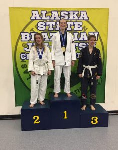 Ria Wildermuth (center) atop the podium at the Alaska State Jiu Jitsu Championship.  Photo courtesy of Pete Keenan