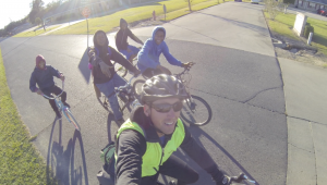 Carter Forney rides alongside local children in Alabama. Photo courtesy of Carter Forney.