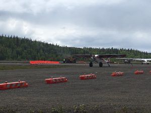 An aircraft uses the temporary taxiway at Talkeetna State Airport as paving work gets ready to begin.  Photo by Katie Writer - KTNA
