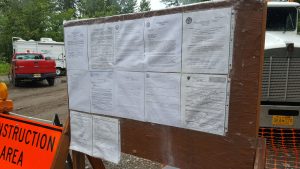 Permits fill a board near the construction site.  Photo:  Phillip Manning - KTNA