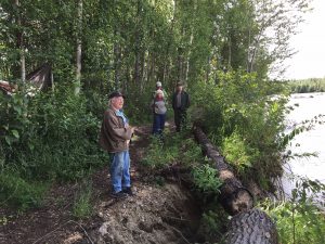 Jonathan Durr stands between the dig site and the eroding riverbank.  Photo:  Katie Writer - KTNA