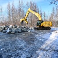 Equipment staged at the end of Main Street in Talkeetna near the river to move rip-rap into place for repairs. Photo: Mat-Su Borough