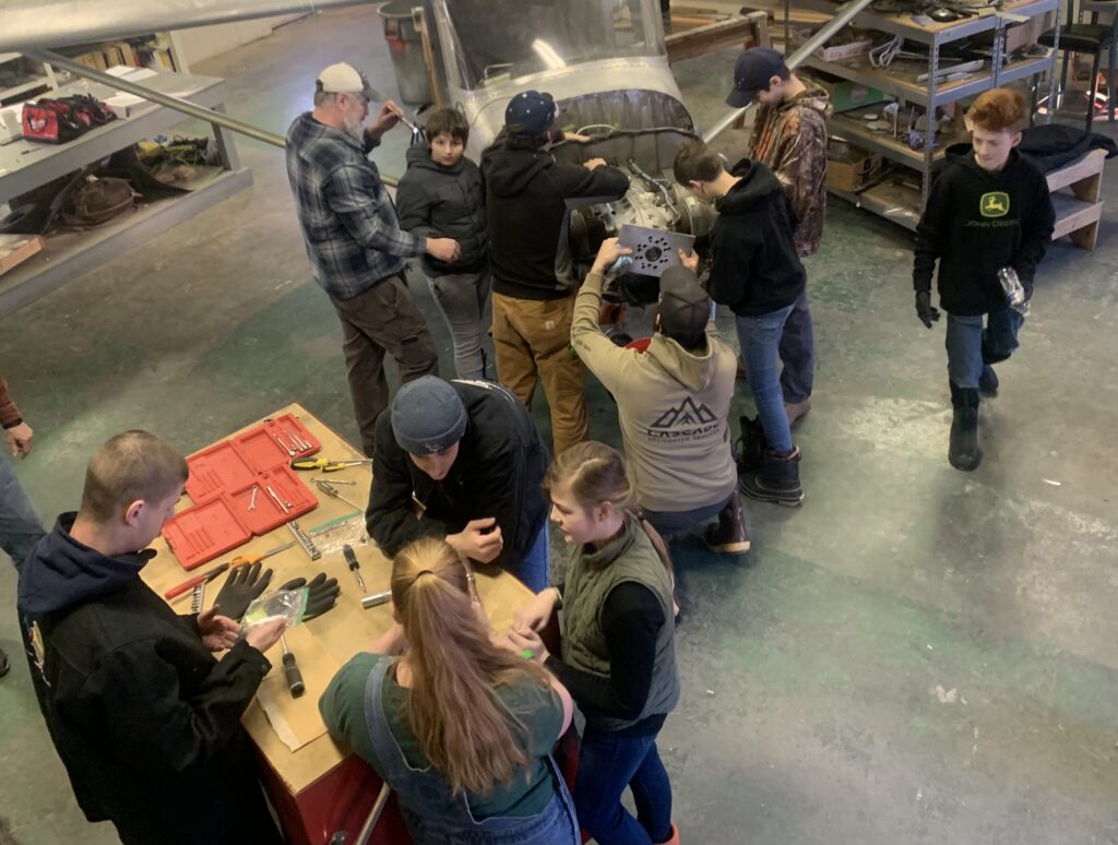 Build-A-Plane Class Tinkers on Plane Engine