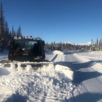 Two Snowcats groom motorized vehicle trails