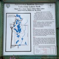 Trailhead sign at Talkeetna Lakes Park with trail information and map.